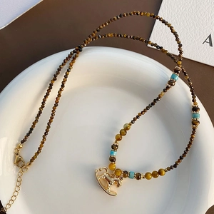 Tiger eye stone beaded necklace with golden rocking horse pendant and adjustable chain