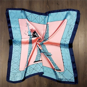 Close-up of square silk scarf with Eiffel Tower print and polished satin texture