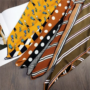 Elegant assortment of printed silk scarves featuring retro patterns on a wooden background