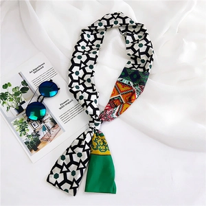 Close-up of long silk-feel scarf with geometric patterns and tropical floral prints