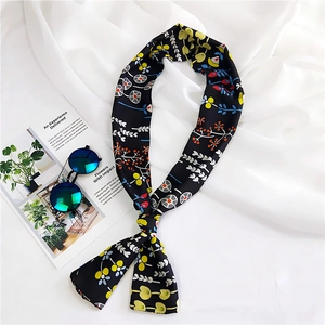 Floral print long skinny scarf styled with sunglasses and magazine on white fabric