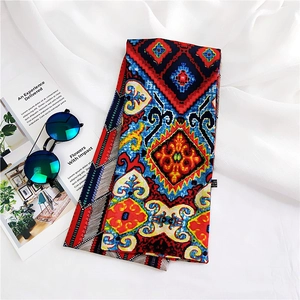 Detail of bohemian floral print silk scarf strip with geometric patterns and neat stitching