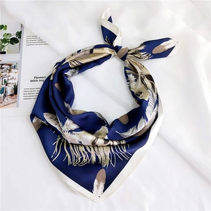 Elegant navy blue square silk scarf with beige feather pattern on a white background