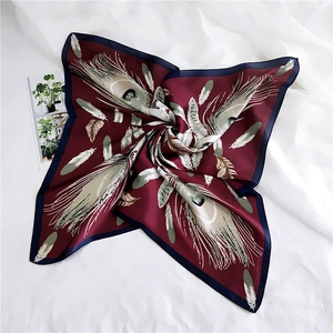 Elegant square silk scarf with burgundy peacock feather patterns on a white background