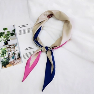 Floral print twilly scarf with blue and pink blocks on cream background flat lay