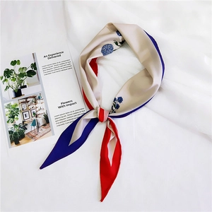 Detail of the diamond flower silk scarf with elegant floral prints and color blocks