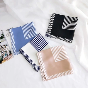 Elegant striped square silk scarves in four colors on a minimalist white backdrop