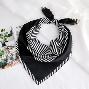 Detail of classic black and white striped silk square scarf showing smooth satin texture