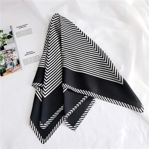 Macro detail of classic black and white striped silk scarf with satin finish on fabric