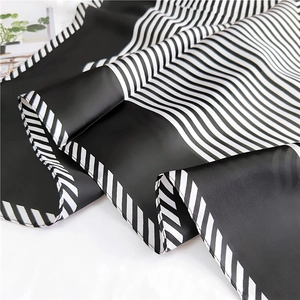 Elegant black and white striped silk scarf with a smooth satin finish and premium texture