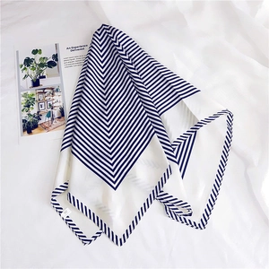 Close-up of chevron stripe square silk scarf with elegant white and navy blue patterns