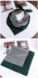 Close-up of dark green and white chevron striped square silk scarf showing texture