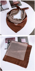 Detail of coffee brown striped square silk scarf with geometric pattern and smooth texture