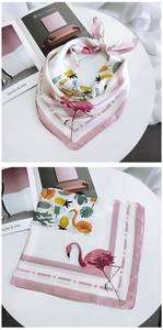 Detail view of square silk scarf with pink flamingo, pineapple and cactus tropical print