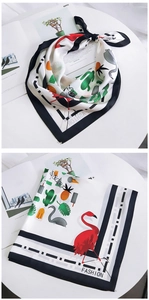 Detail of square silk scarf with tropical flamingo and pineapple pop art print patterns