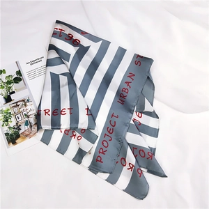 Detail view of a striped silk square scarf with modern Project Urban Street text print