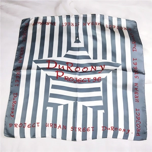 Detail of grey and white striped satin square scarf featuring DuRoonY PROJECT typography