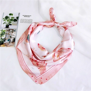 Detail of pink silk square scarf with flamingo pattern and geometric stripes decoration