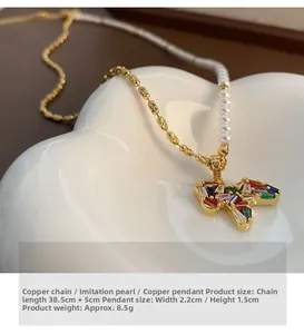 Detail of butterfly pendant necklace with colorful zircons and imitation pearls