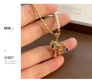 Detail of horse pendant necklace with colorful crystals and pearl beaded gold chain