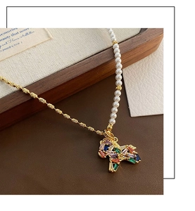 Detail of horse pendant necklace with colorful zircons and white pearls on gold chain