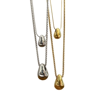 Gold and silver teardrop pendant necklaces featuring snake and box chains on white background
