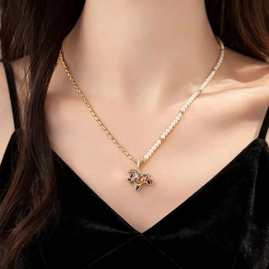 Elegant asymmetrical pearl and gold chain necklace with colorful pony horse pendant
