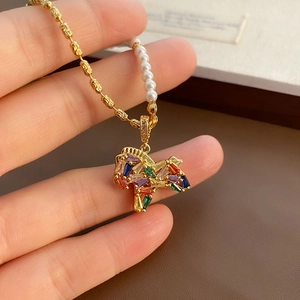 Exquisite horse pendant necklace with rainbow gemstones and elegant pearl chain detail