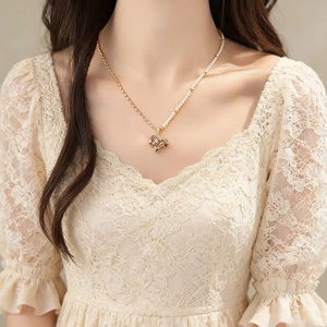 Elegant gold pony pendant necklace featuring pearl stitching and asymmetric chain