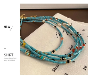 Detail of five-layer beaded necklace with turquoise stones, pearls and lobster clasp