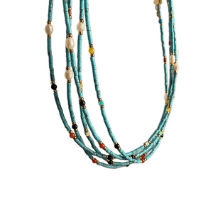 Multilayer beaded necklace with turquoise stones, white pearls and gold accents for women