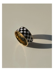 Close-up of checkerboard patterned ring with a polished 18K gold plated finish