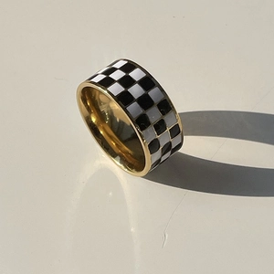 Classic black and white checkerboard ring with 18K gold plated titanium steel finish