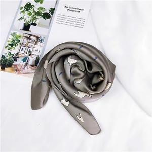 Détail d'un foulard en soie à motifs d'alpagas au lustre doux en gris olive