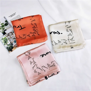 Three elegant satin square scarves with Eiffel Tower prints in coral, beige, and pink colors