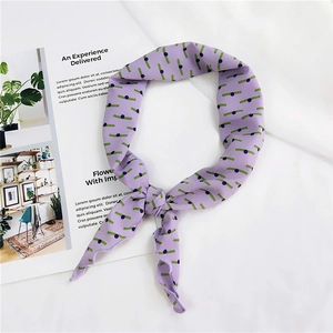 Detail shot of purple patterned silk scarf with green stripes and dark violet dots texture