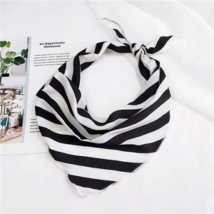Detail of black and white striped neck scarf with fine white edge stitching on soft fabric