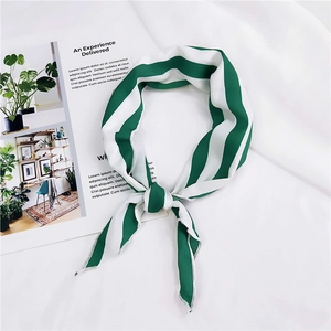 Detail of green and white striped silk scarf with knot styling and fine hem edges