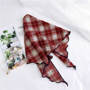 Close-up of red and blue checkered silk scarf with decorative wavy lettuce edge