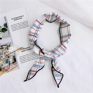 Close-up of elegant plaid neckerchief with black piping and red blue grid pattern