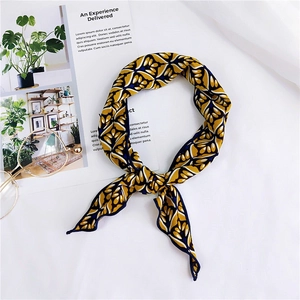 Detail shot of a yellow vintage floral silk scarf with glasses on a white magazine background