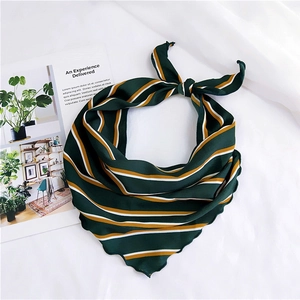 Detail of green striped silk scarf showing the wavy edge finish and soft fabric texture