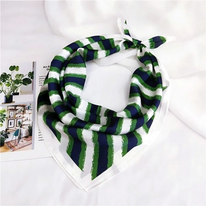 Green and blue striped square silk scarf with artistic brushstroke pattern flat lay view