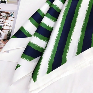 Detail of silk scarf with green, navy and white stripes showing fine rolled edges