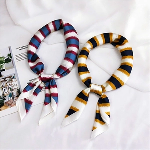 Macro detail of red and blue striped satin scarves on white fabric background