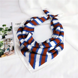 Detail of diagonal blue and brown striped silk scarf with brush texture on white fabric