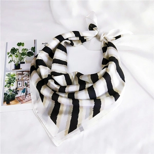 Detailed close-up of striped silk square scarf with elegant black and white pattern
