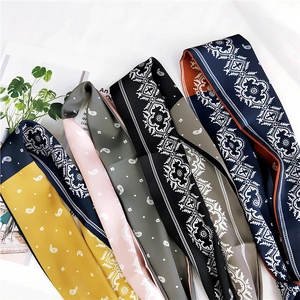 Close-up of assorted paisley pattern skinny silk scarves in vibrant various colors