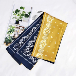 Detail of silk scarves with paisley pattern in navy blue and golden yellow colors