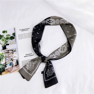 Detail of gray and black paisley silk-like neckerchief styled with a decorative knot